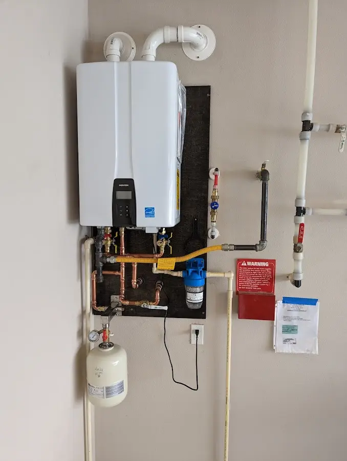 Professional plumber installing copper piping in a Menasha home